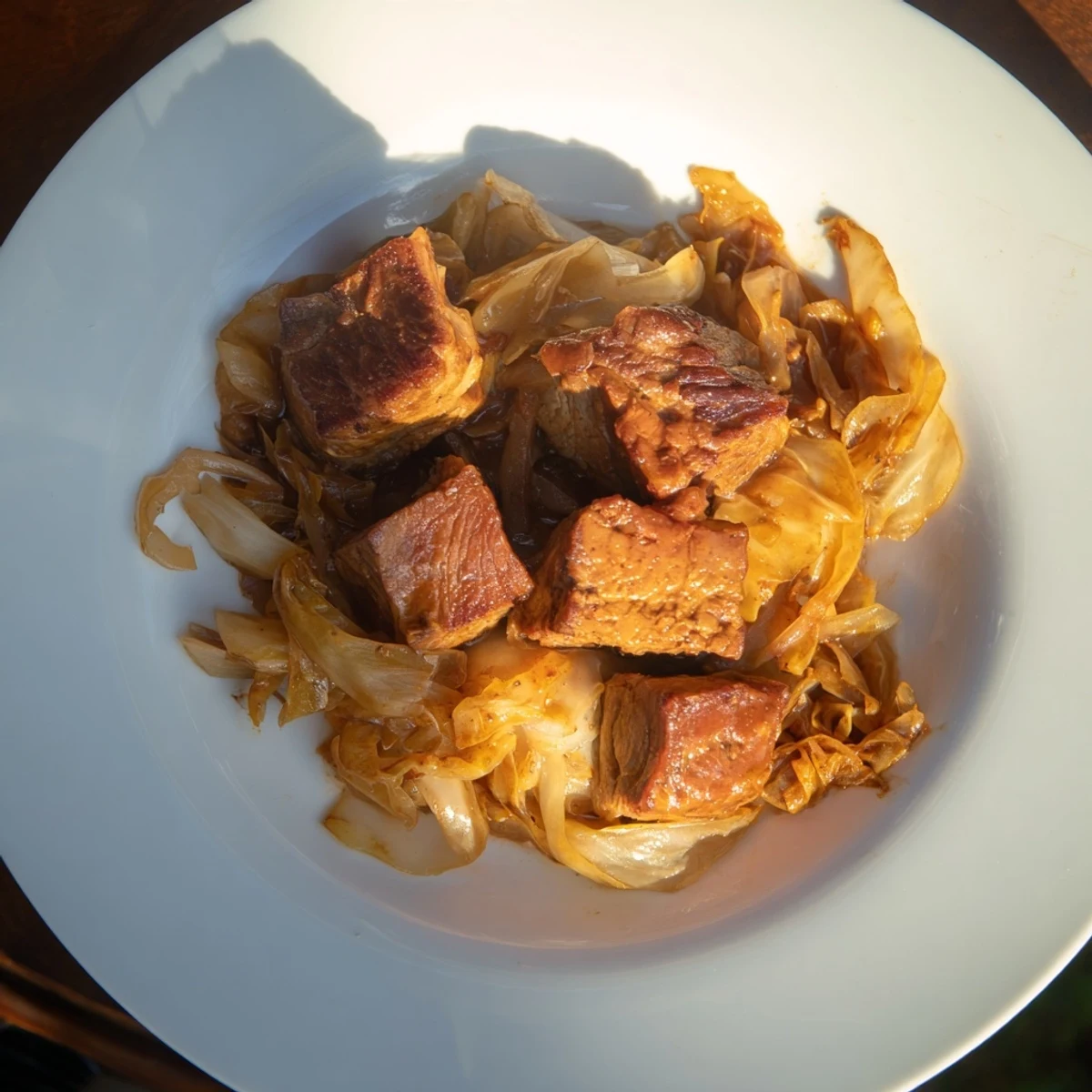 Sizzling close-up of Sweet Cabbage and Pork Stew, rich and savory, perfect for a cold evening meal.