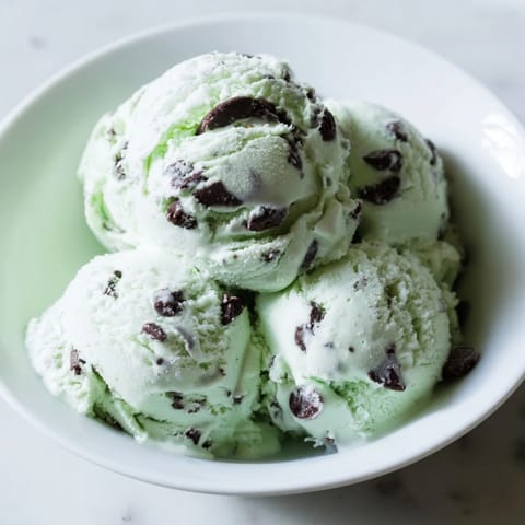 A scoop of refreshing mint chocolate chip ice cream, ready to enjoy on a warm summer day.